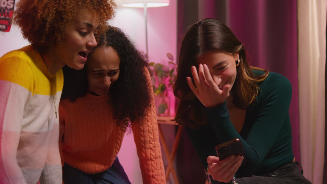 Friends laughing at something on their phones