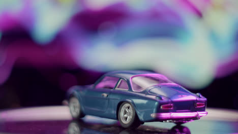 blue toy car with abstract purple and blue background