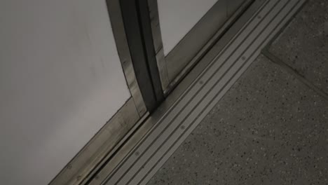 an interior selected focus view at opening doors subway, view of the doors on a commuter subway car as they open at an empty platform