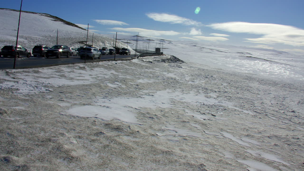 Extra Wide shot of the Hardangervidda mountain plateau at Dyranut with the R7 road in April 2025