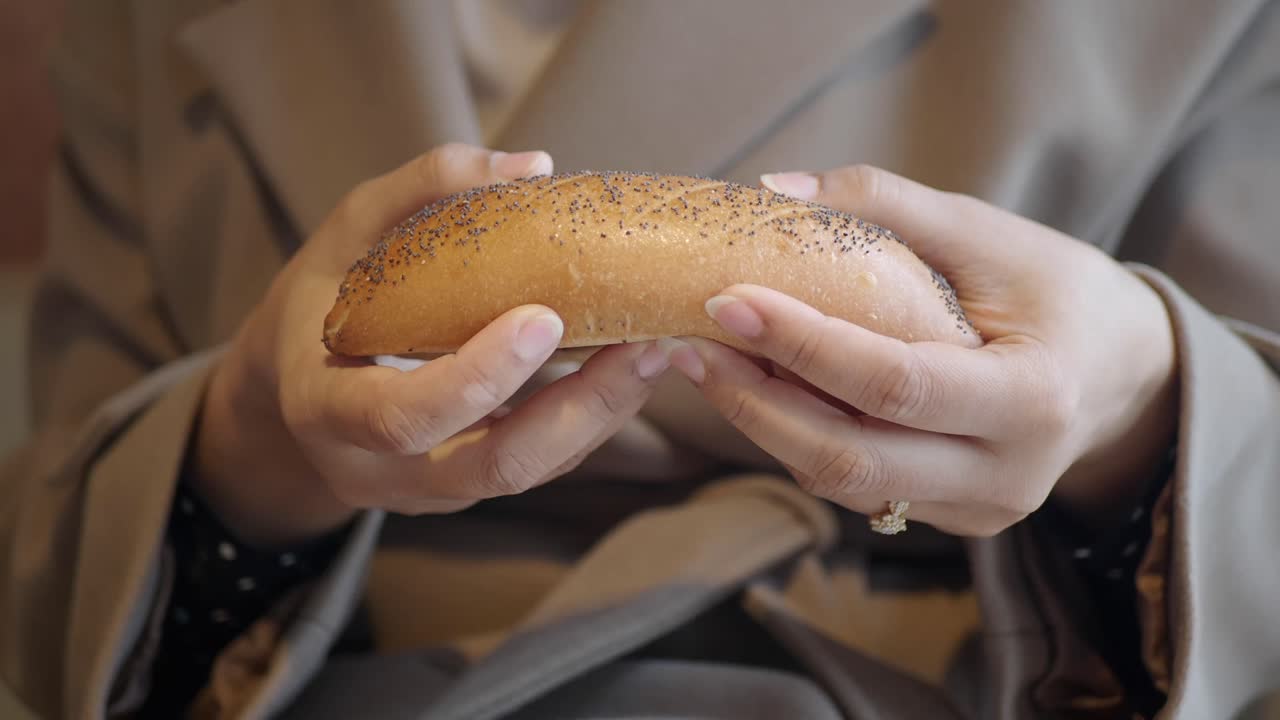 A bread roll being broken apart