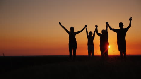 Active-Healthy-Family-Grandmother-With-Daughter-And-Grandchildren-Meet-The-Dawn-Raise-Their-Arms-Abo