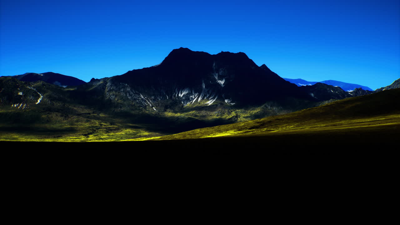 Majestic mountain landscape under clear blue sky at dusk