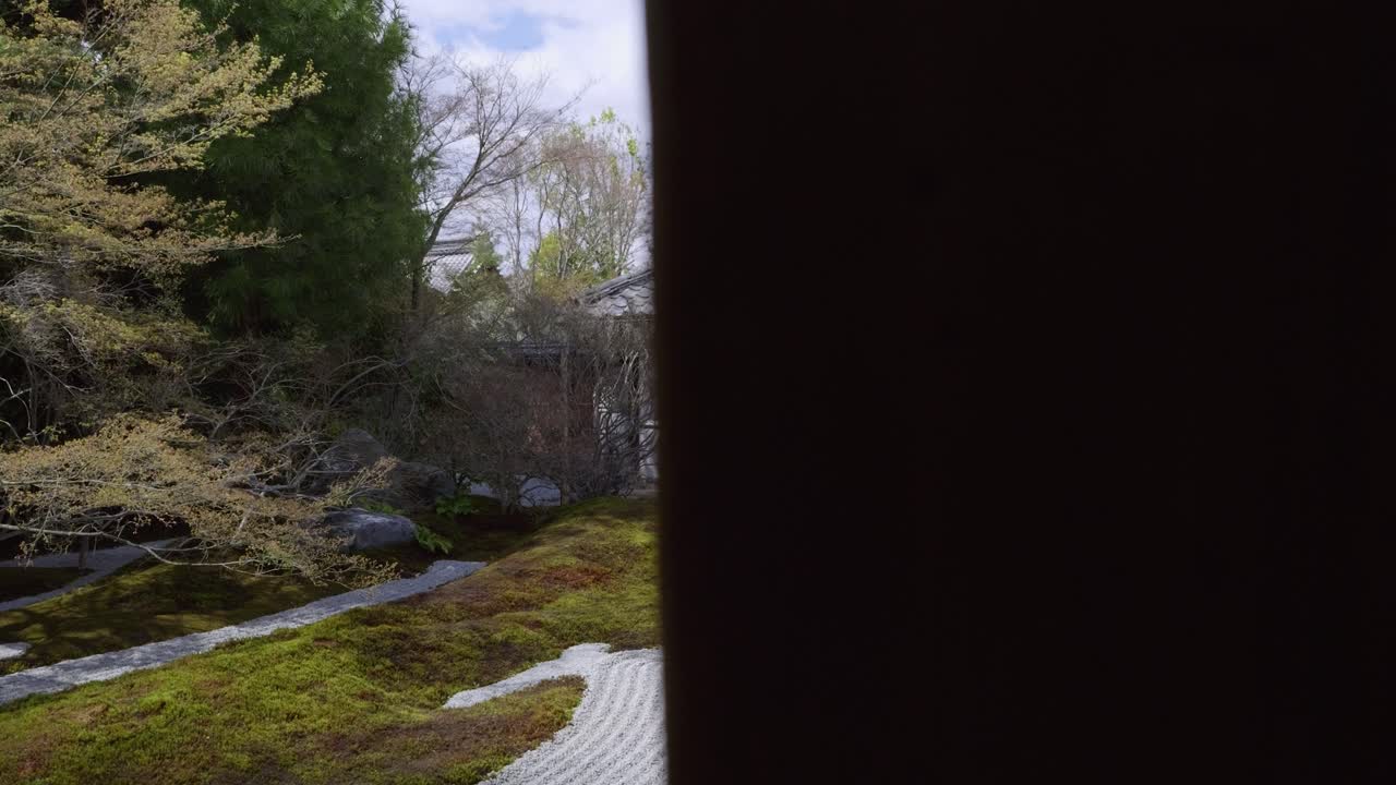 Slow cinematic reveal over beautiful buddhist temple grounds with Zen garden