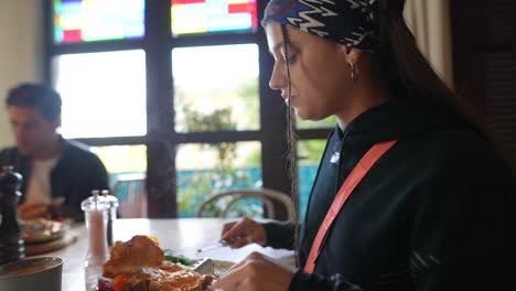 una mujer desayunando en un restaurante.