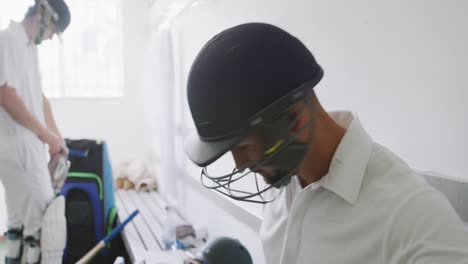 cricket playing putting on his helmet before playing