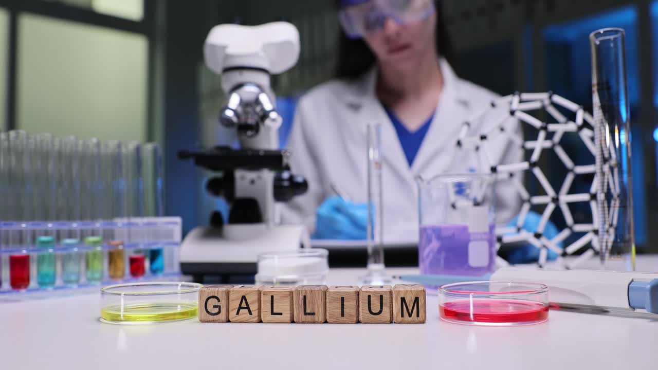 Scientist working in a laboratory with Gallium blocks and various lab equipment
