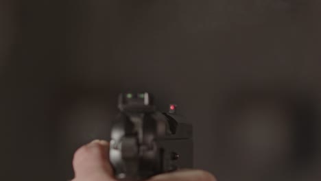 9mm pistol with the hammer striking down on firing pin and shooting a bullet in slow motion