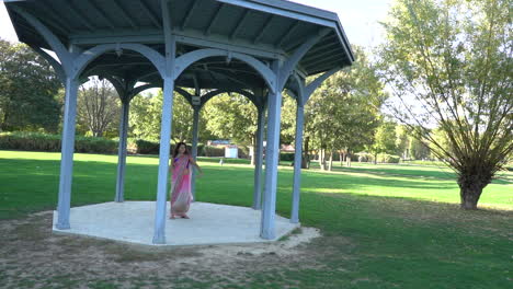 Happy-woman-dancing-outdoors,-slow-motion