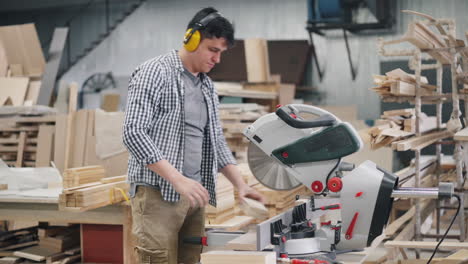 carpenter using circular saw in workshop