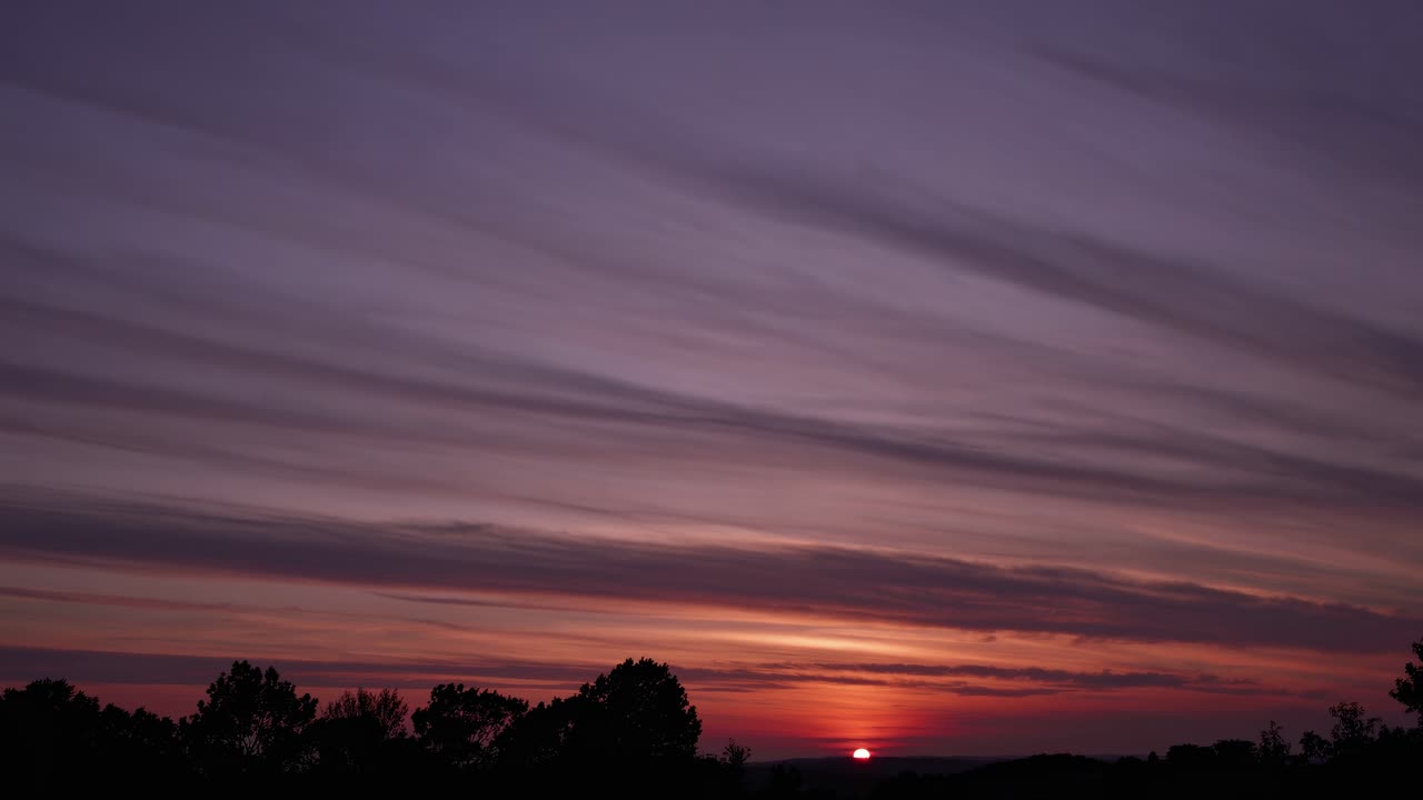 A serene sunset video scene with a low-angle view, capturing the horizon's vibrant hues