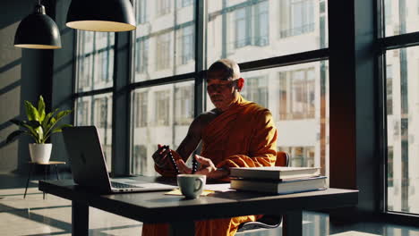 monk meditating in a modern office