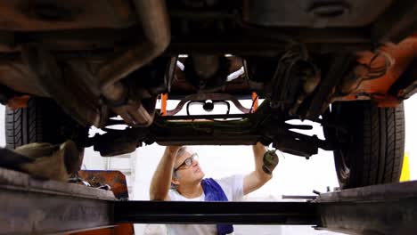 male mechanic servicing a car 4k