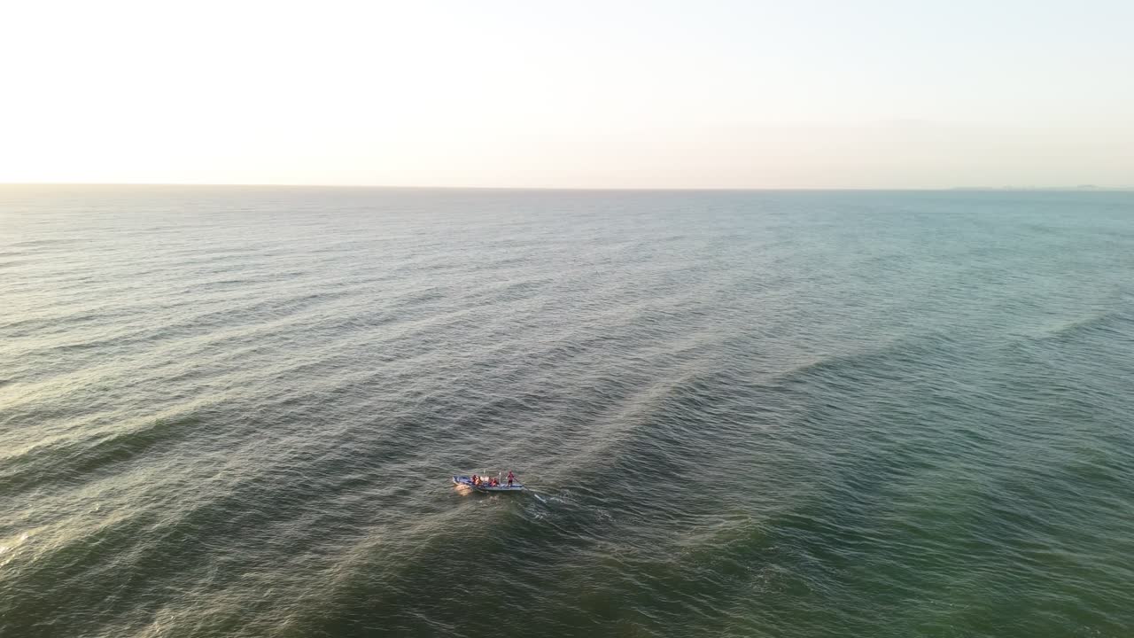 Rowers heading out to sea at sunrise in Gold Coast waters