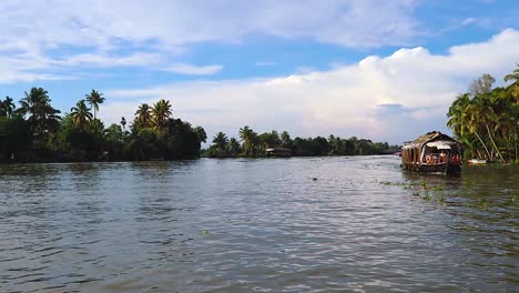 sea backwater with many traditional houseboats running and amazing sky at morning video taken at alappuzha or alleppey backwater kerala india