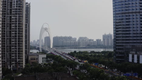 view of liede bridge with heavy traffic, cars, taxis, public transport moving over the zhujiang river in downtown of guangzhou, guangdong, china, asia, aerial shot