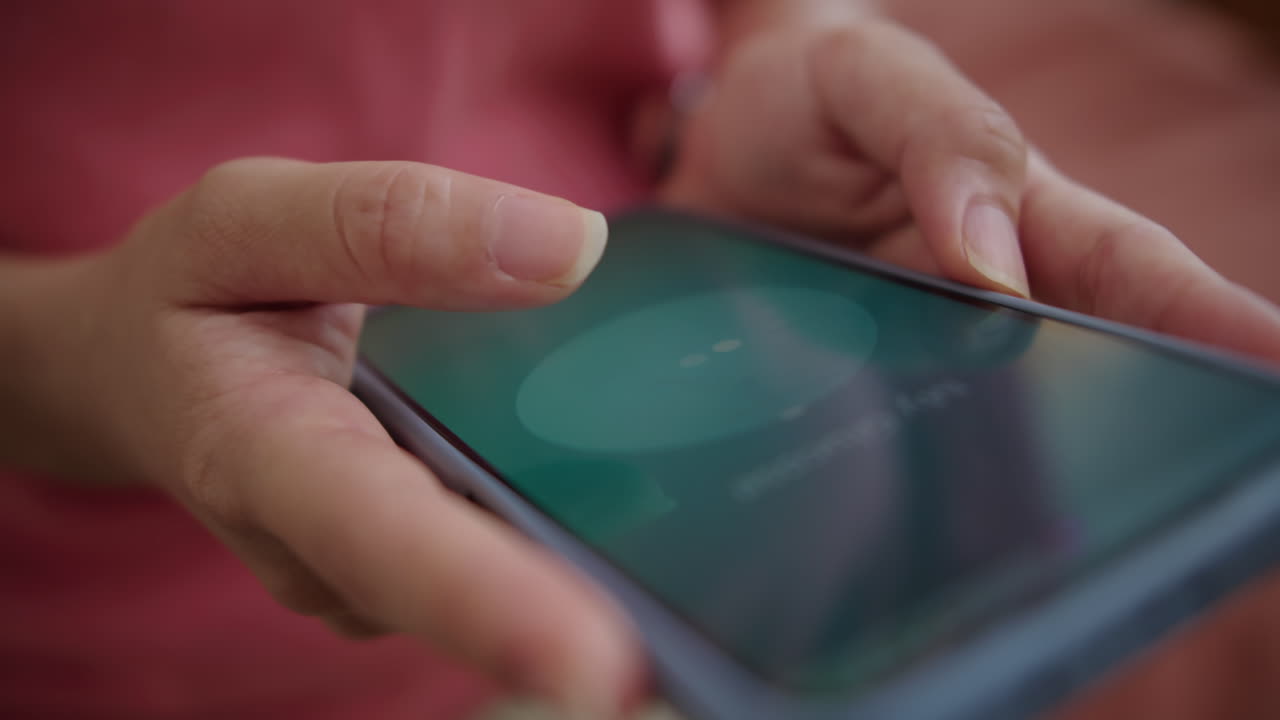 Hands of Person Unlocking Screen and Playing Video on Smartphone