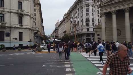 people cross the street at plaza de mayo cathedral historic center of buenos aires argentina