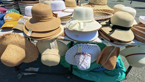 various hats displayed at a naples street market