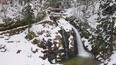 Ginzan-Onsen-in-Winter,-Waterfall-and-Snow-Covered-Landscape-in-Yamagata