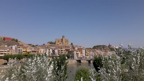 a captivating drone reveal of the catholic church santa maria de balaguer in lleida, spain, bathed in the warm afternoon sun