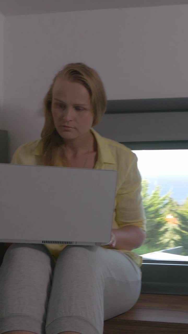Woman working on a laptop indoors