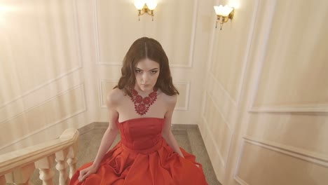 woman in red dress on stairs