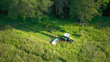 Mower-machine-cutting-grass-of-uncultivated-green-field