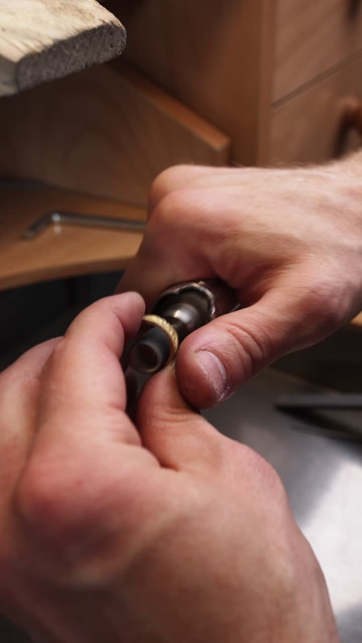 Close-up of Jeweler's Hands Polishing a Gold Ring