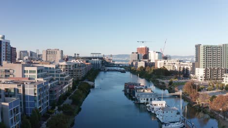 wide rising aerial shot looking down the mission creek channel towards mission bay in san francisco