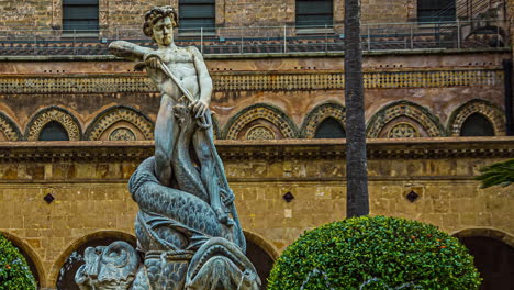 ancient statue fountain in front of the cathedral of monreale near palermo in sicily, italy