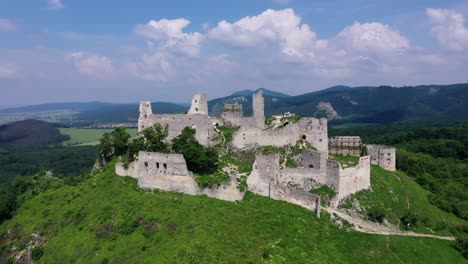 aerial footage of a ruined medieval castle on a hill, slovakia