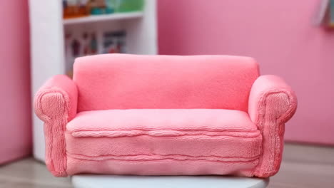 miniature pink couch in a pink room