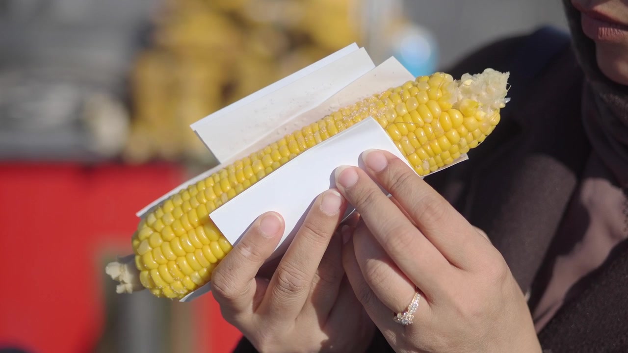 Woman Eating Fresh Steamed Corn on the Cob