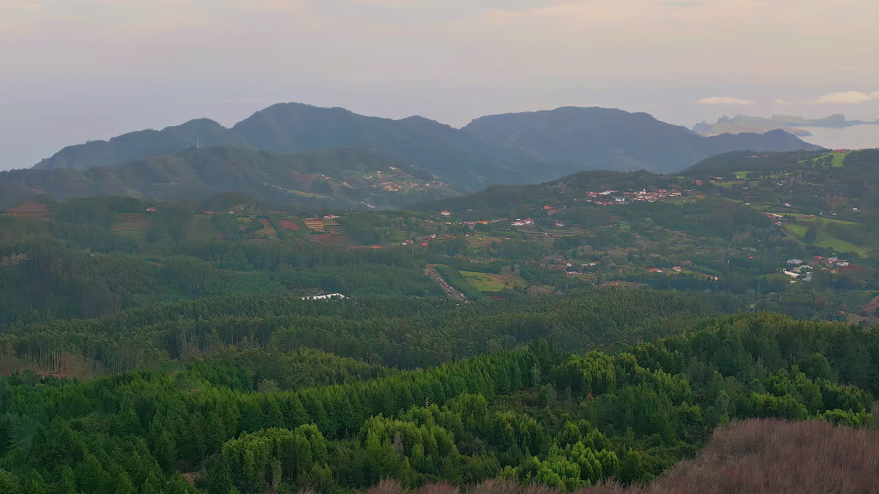 Panoramic aerial green mountains with scattered villages. Countryside landscape