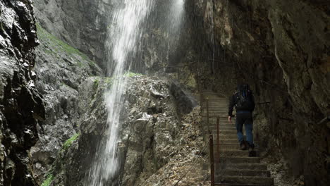 hiking under waterfall in mountain rocks in germany