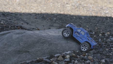 remote control vehicle on rock, blue color