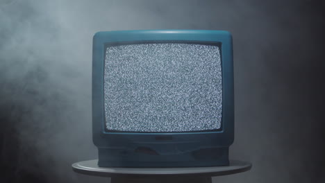 vintage tv with static noise in smoky room