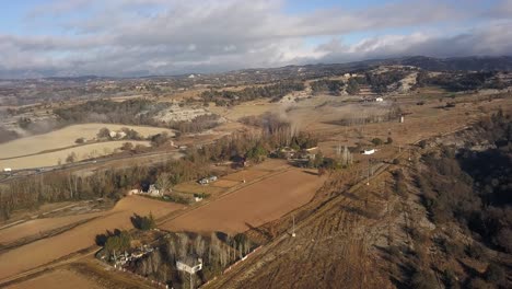 Aerial-view-of-rural-area-with-flat-dry-land-crossed-by-country-roads