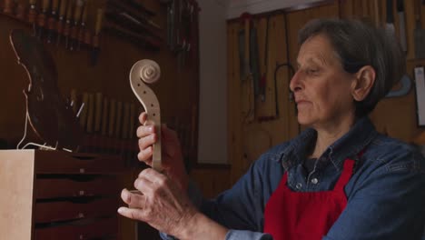 female luthier at work in her workshop