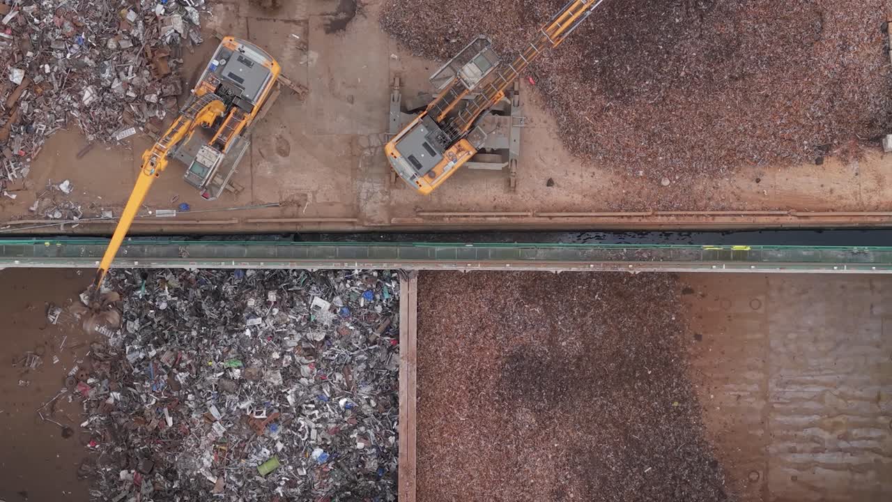 Scrap metal being loaded by excavators at Limerick port for export by ship