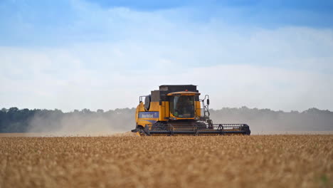 modern yellow-and-black harvester combine moving the agricultural field. working machinery on a busy harvest season. two combiners driving the vehicle.