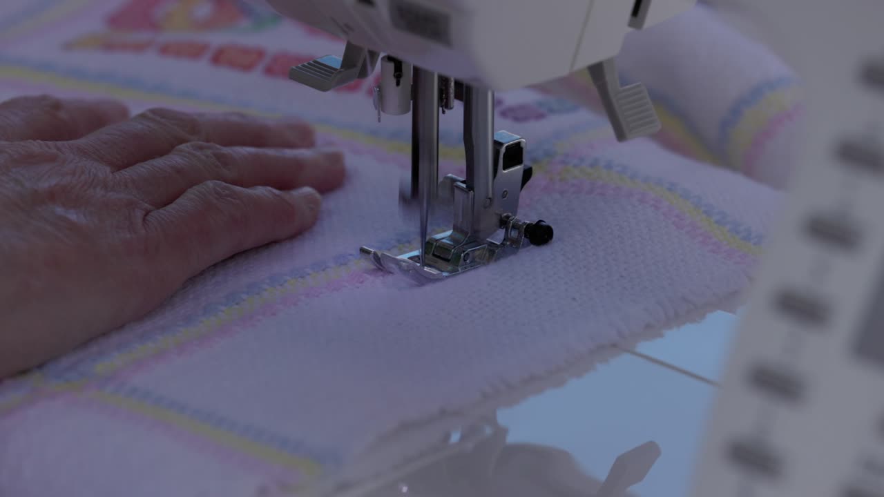 security stitches being added to finish off a baby blanket to sell