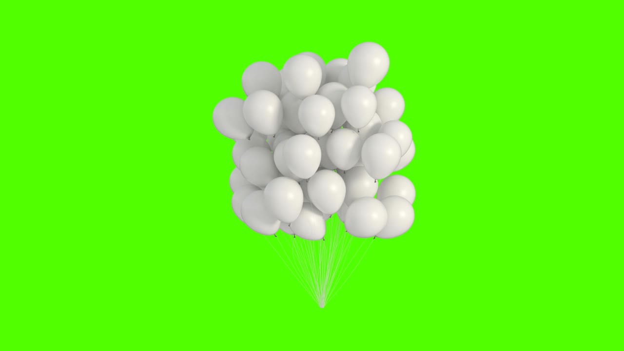 초록색 배경에서 바람에 흔들리는 색 풍선의 어리