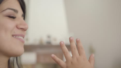 rostros en primer plano de una mujer y un niño de oriente medio sonrientes frotándose las narices