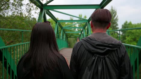 Aisan-couple-walking-on-bridge-side-by-side,-slow-motion