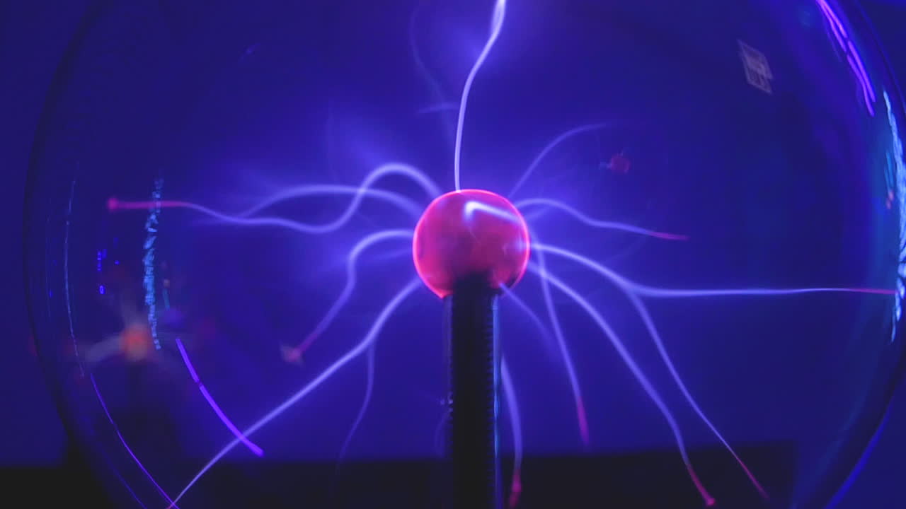Plasma Globe. Voltage Electricity radiates in this pink and purple science experiment. Slow Motion.