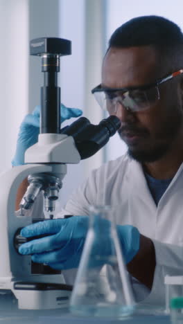 scientist using a microscope in a laboratory setting