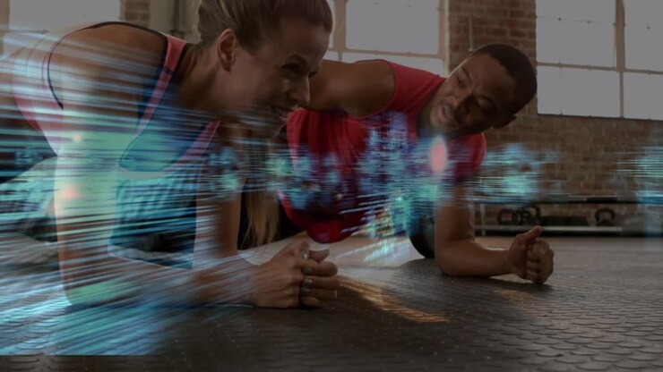 Medical data processing against biracial fit couple performing plank exercise at the gym