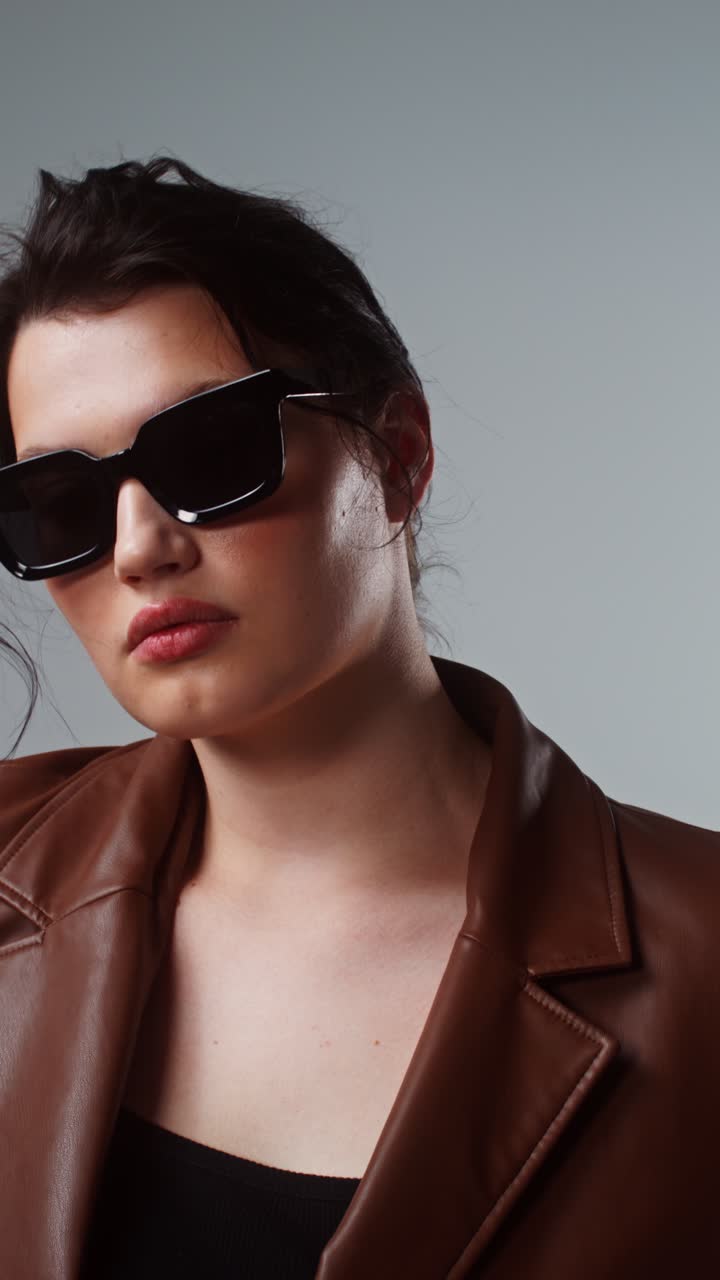 Stylish Woman in Sunglasses and Leather Jacket